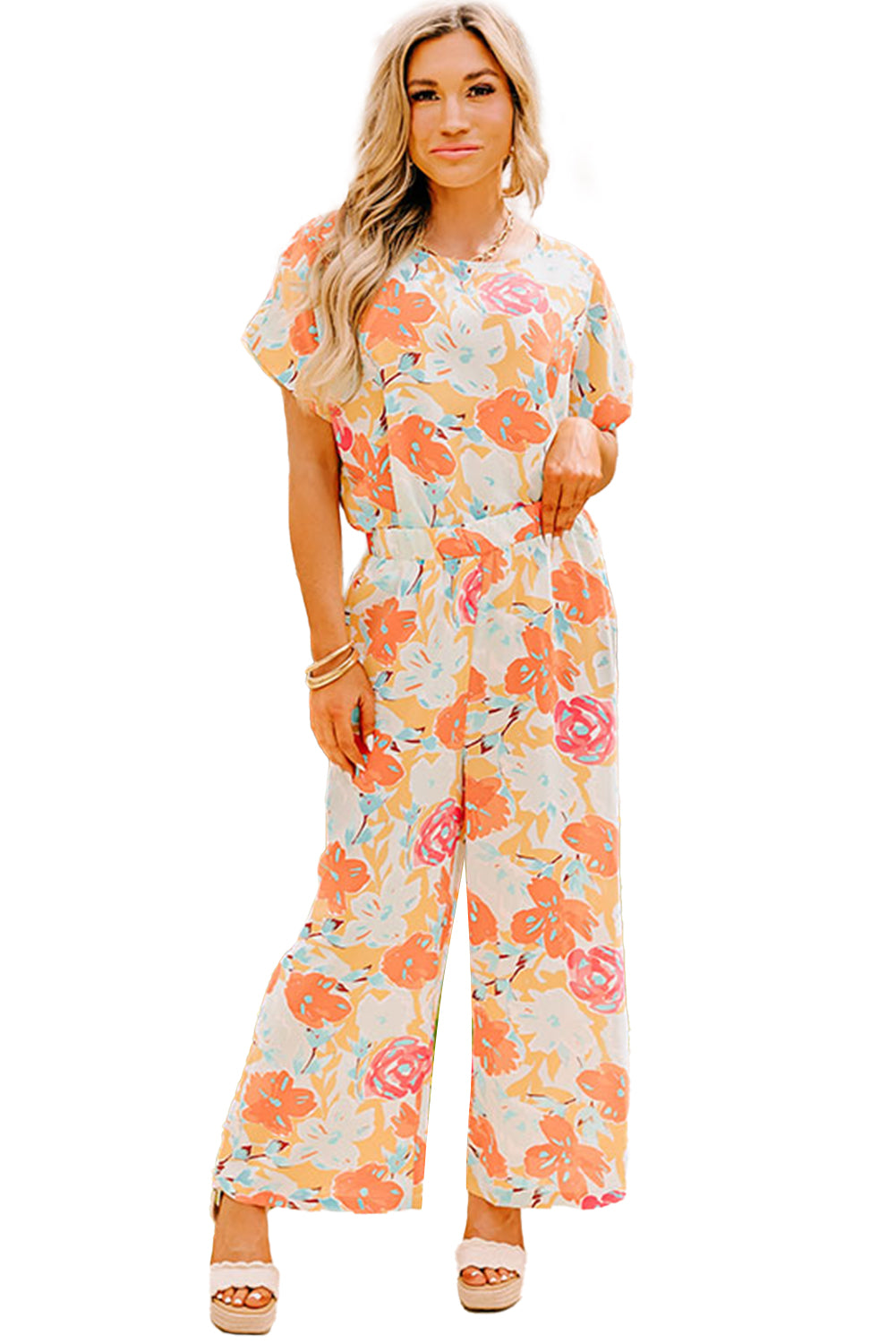 Orangefarbenes Set mit Bluse und Hose mit weitem Bein und kräftigem Blumenmuster